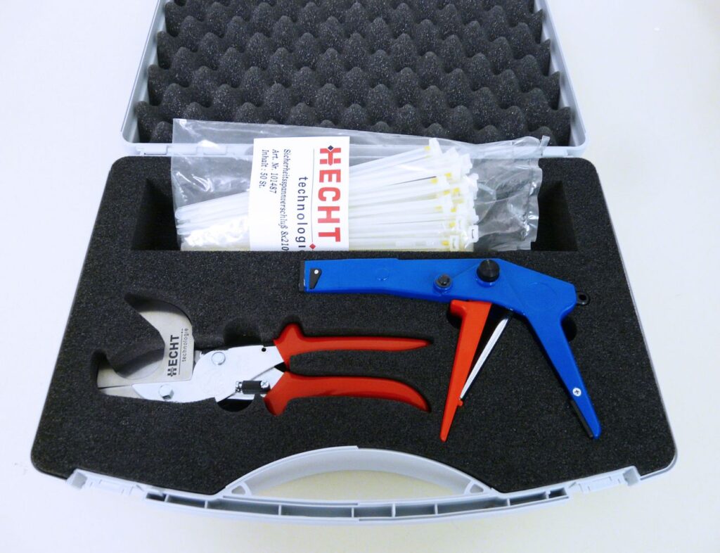 Customized HECHT containment kit, including powder sampling sticks packaged in a clear plastic bag, wire cutters, and a blue-handled crimping tool, all securely nestled within a tailored, cushioned metal case with the HECHT logo.